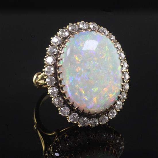 An 18ct gold, white opal and diamond oval cluster ring, size N.